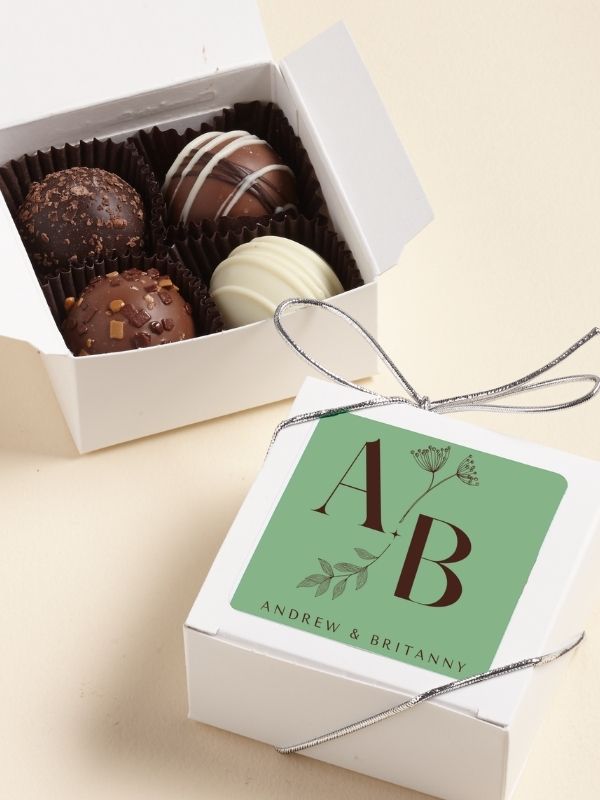 4 pc Custom Sticker Truffles assortment favor in a white box.