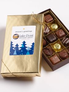 1/2 lb box of chocolate wrapped in gold with a custom logo sticker