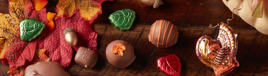Assorted chocolates and fall & thanksgiving decor for holiday harvest