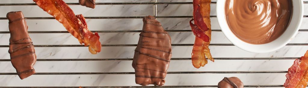 slices of bacon and chocolate bacon on a metal rack.