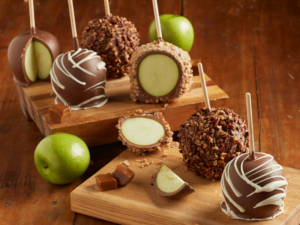 Assortment of chocolate caramel apples, pecan apples and toffee apples.