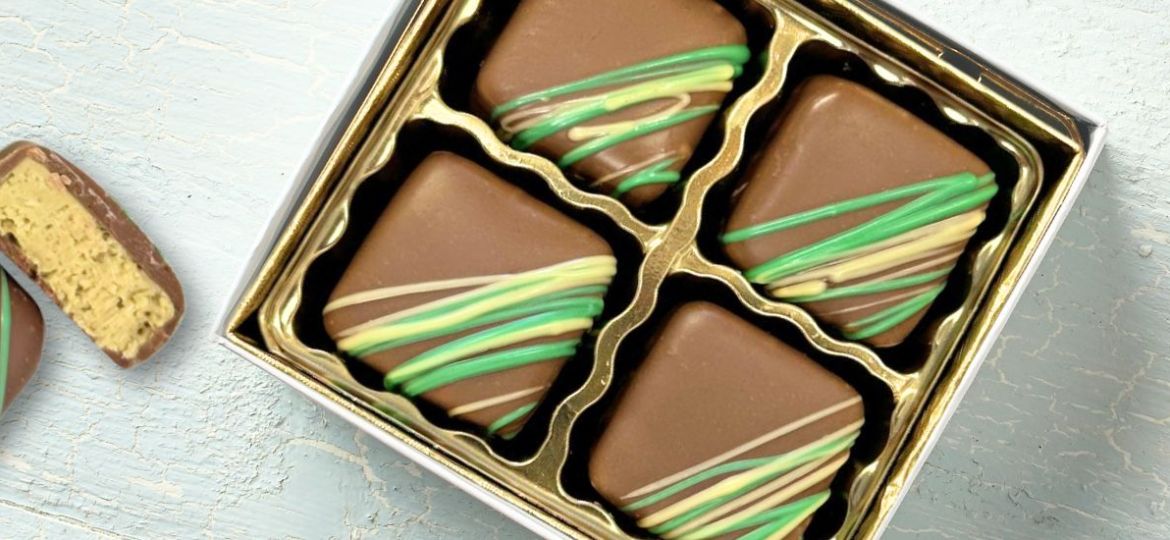 4pc gift box of dubai milk chocolates and 1 piece of a cut open dubai chocolate
