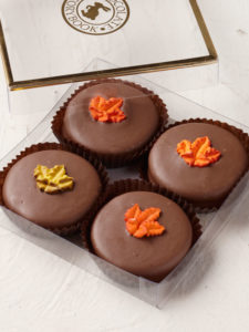 4 oreos covered in milk chocolate and topped with a fall leaf icing decal