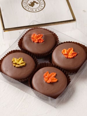 4 oreos covered in milk chocolate and topped with a fall leaf icing decal